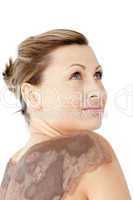 Portrait of a woman enjoying a mud skin treatment