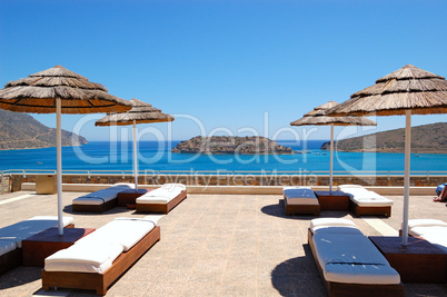 Sunbeds at luxury hotel with a view on Spinalonga Island, Crete,