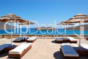 Sunbeds at luxury hotel with a view on Spinalonga Island, Crete,