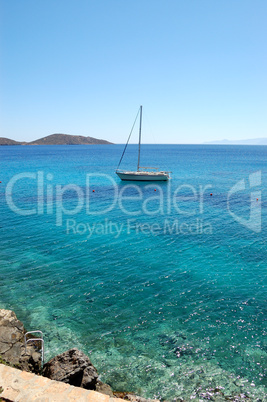 Turquoise Aegean Sea and yacht, Crete, Greece