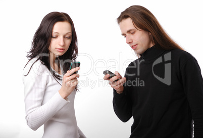 Young couple texting by phone