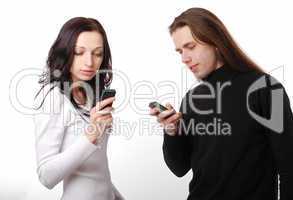 Young couple texting by phone