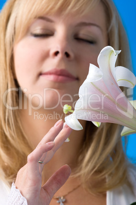 woman smelling lily