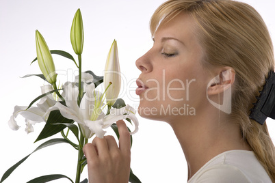 woman smelling lily