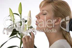 woman smelling lily