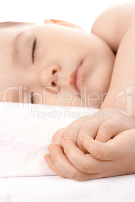 Sleeping little child, clasping his hands together