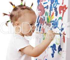 Little girl paint on a board
