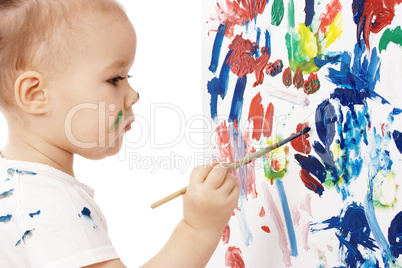 Little girl paint on a board
