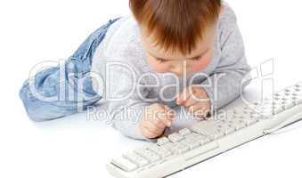 Cute child typing on a keyboard