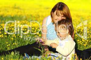 Mother and her child play on meadow