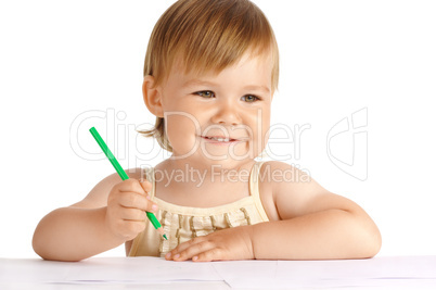 Happy child with green crayon