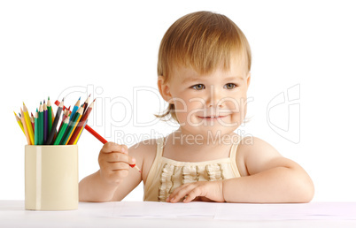 Happy child draw with red crayon