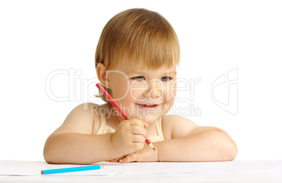 Happy child smile and draw with red crayon