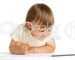 Child draw with orange crayon