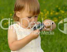 Child looking at snail through magnifying glass