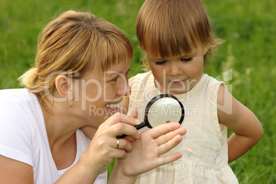 Child with mother looking at snail