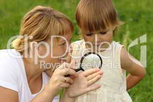 Child with mother looking at snail