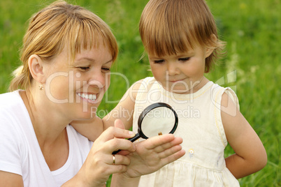 Child with mother looking at snail