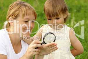 Child with mother looking at snail