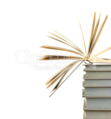 A pile of books and the one open at top