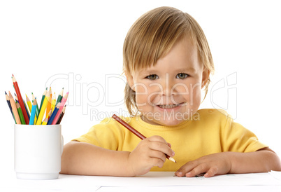 Cute child draw with crayons and smile