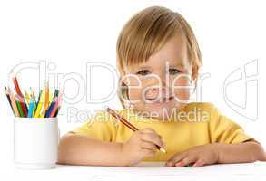 Cute child draw with crayons and smile