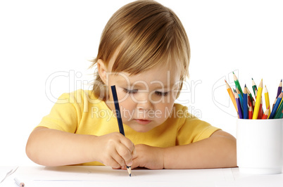 Cute preschooler focused on her drawing