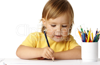Cute preschooler focused on her drawing