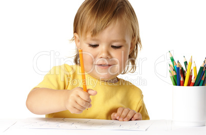 Happy child draw with crayons and smile