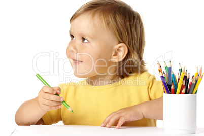 Happy child play with crayons and smile