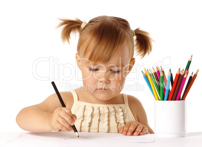 Cute preschooler focused on drawing