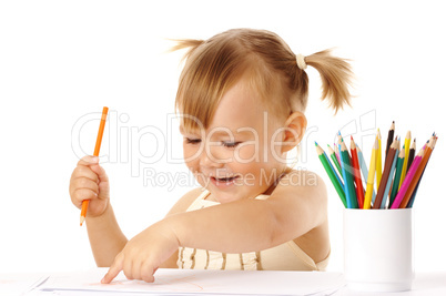 Happy child points on her drawing and smile