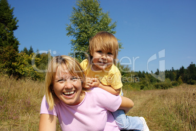 Mother and child play outdoors