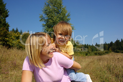 Mother and child play outdoors