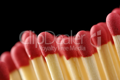 Wave of red matchsticks on black background