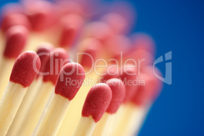 Red matchsticks on blue background