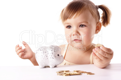 Cute little girl with piggybank