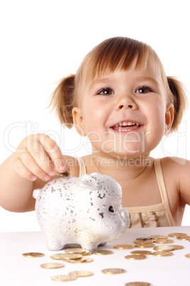 Cute little girl with piggybank