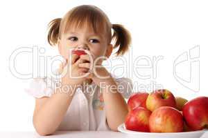 Child eats red apple