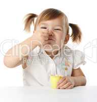 Funny Little girl eats yogurt
