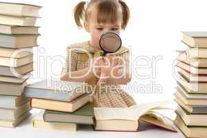 Little girl looking at her nails through magnifier