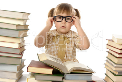 Little girl with books wearing black glasses