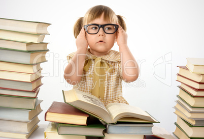 Little girl with books wearing black glasses