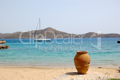Beach of luxury hotel with yacht and amphora view, Crete, Greece