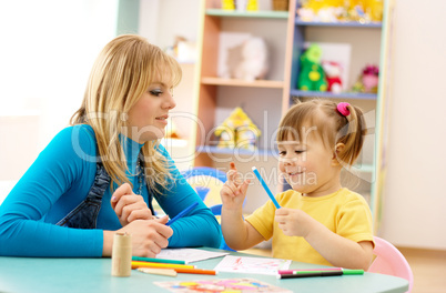 Teacher with child in preschool