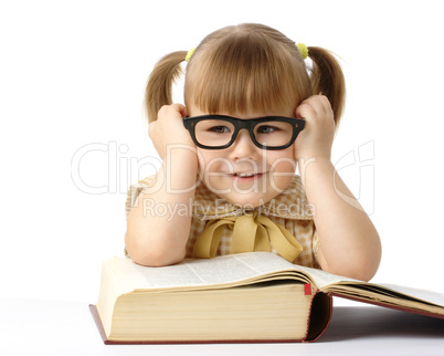 Happy little girl with book wearing black glasses