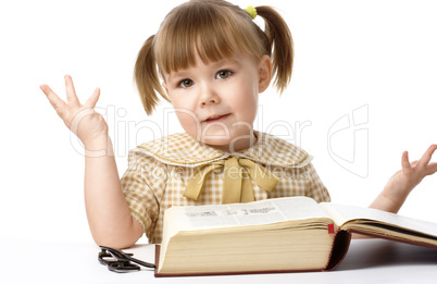 Happy little girl with book, back to school