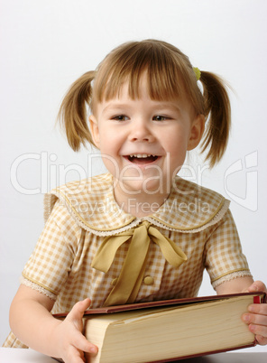 Happy little girl with book, back to school