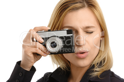 young woman taking a shot with photo camera