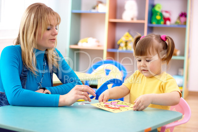 Teacher with child in preschool